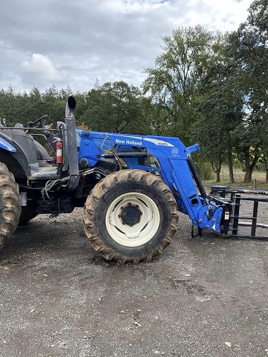 Side view of tire on blue, New Holland agricultural equipment